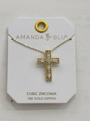 A gold cross pendant necklace with clear stones, displayed on a white branded card labeled Amanda Blu. The card also reads 'CUBIC ZIRCONIA 18K GOLD DRIED'.