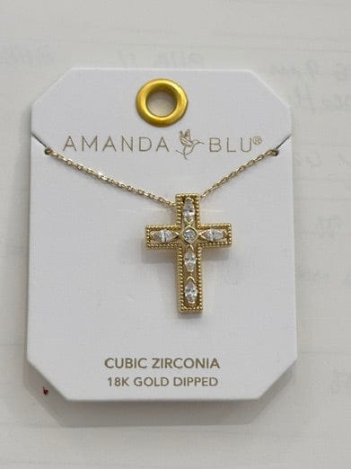 A gold cross pendant necklace with clear stones, displayed on a white branded card labeled Amanda Blu. The card also reads 'CUBIC ZIRCONIA 18K GOLD DRIED'.