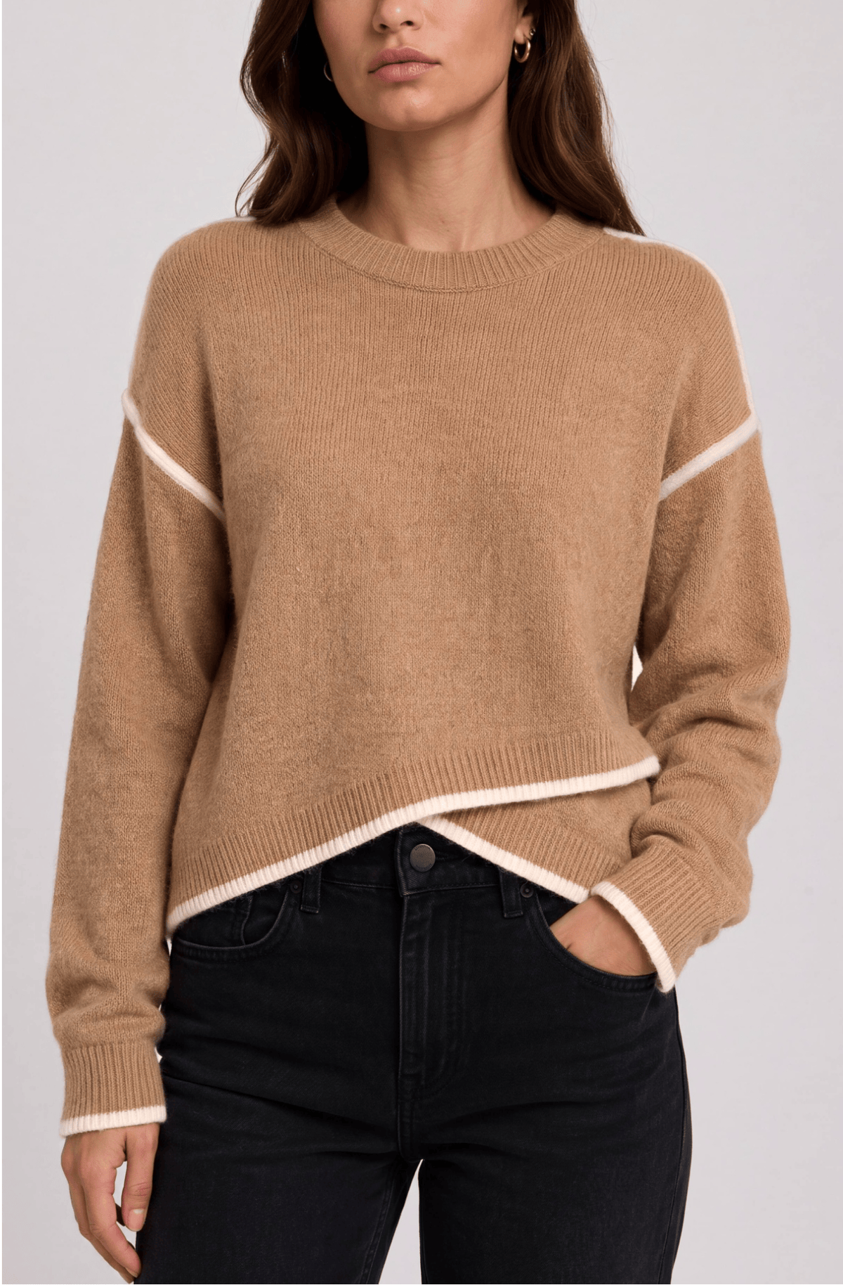 Camel crewneck sweater with cream trim and tulip hem, worn by a model