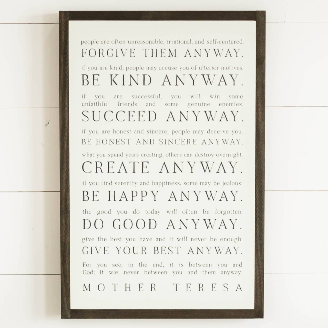 Love them Anyway | Mother Teresa | Wall Art: Soft White-Black Text / Dark Brown Frame / 8 inches x 12 inches Joyfully Said